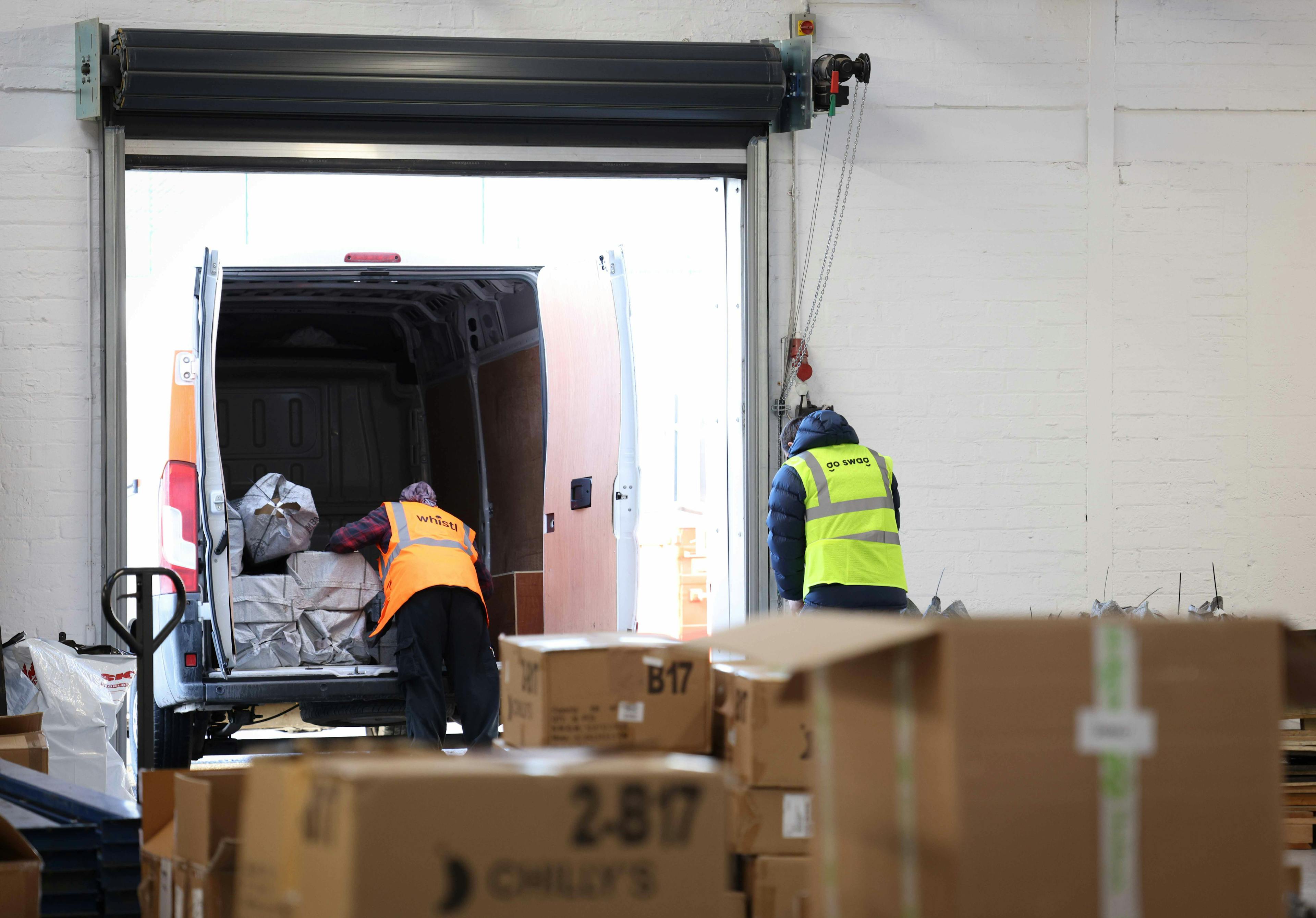 Photograph of packages being unloaded in a warehouse