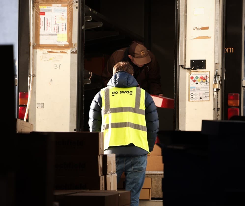 A Go Swag team member loading parcels with a UPS driver.